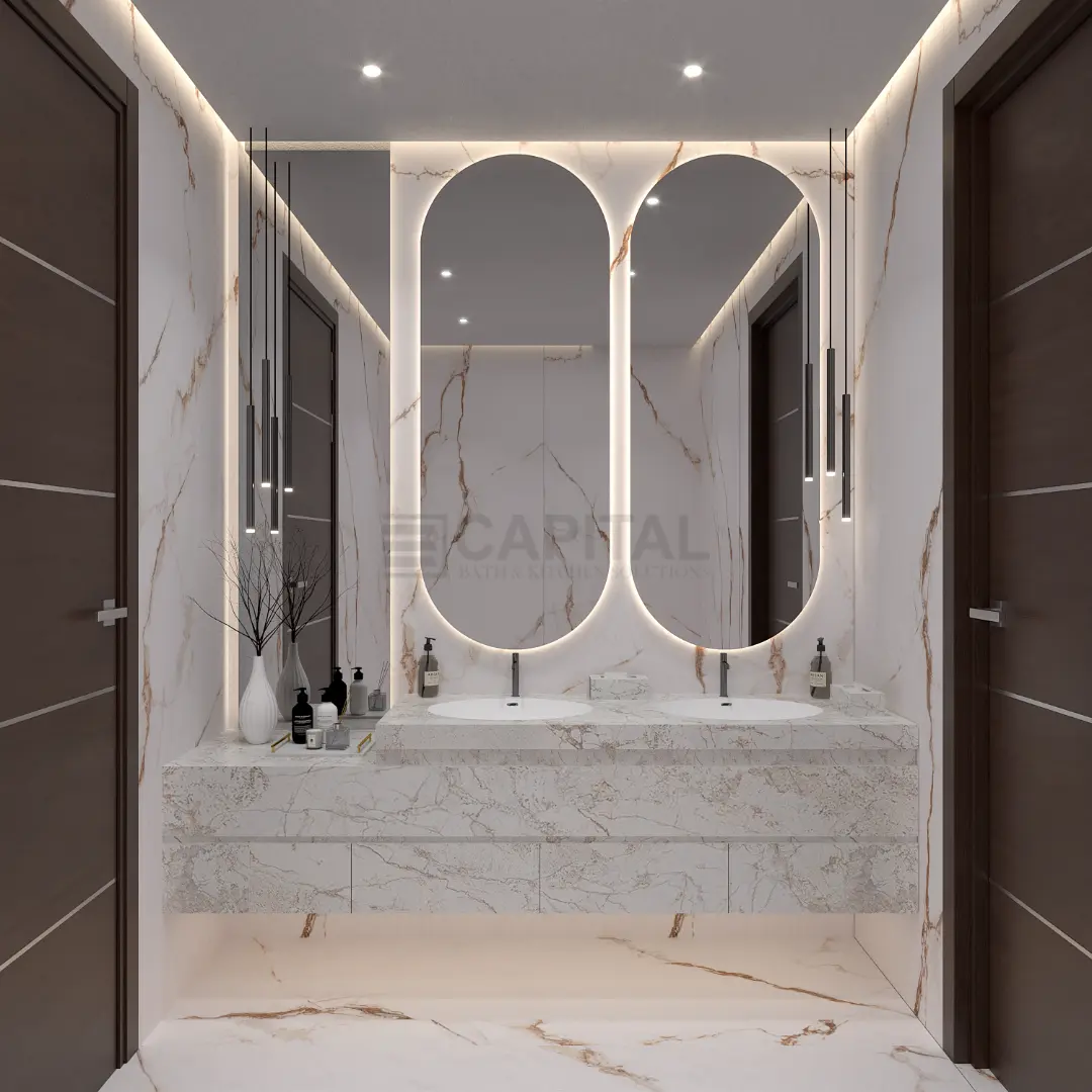 
Modern luxury bathroom double vanity featuring a floating white marble counter, floor-to-ceiling marble tiles with gold veining, two large oval backlit mirrors, and sleek black pendant lights.