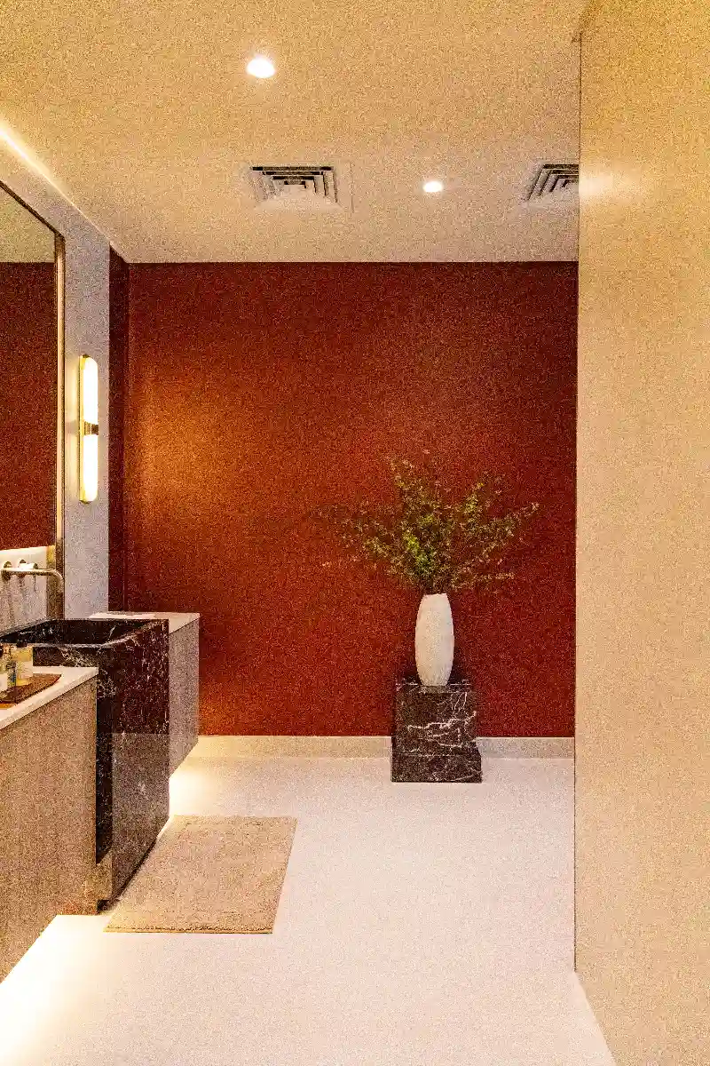 Terracotta Accent Wall with Porcelain Plinth and Botanical Vase